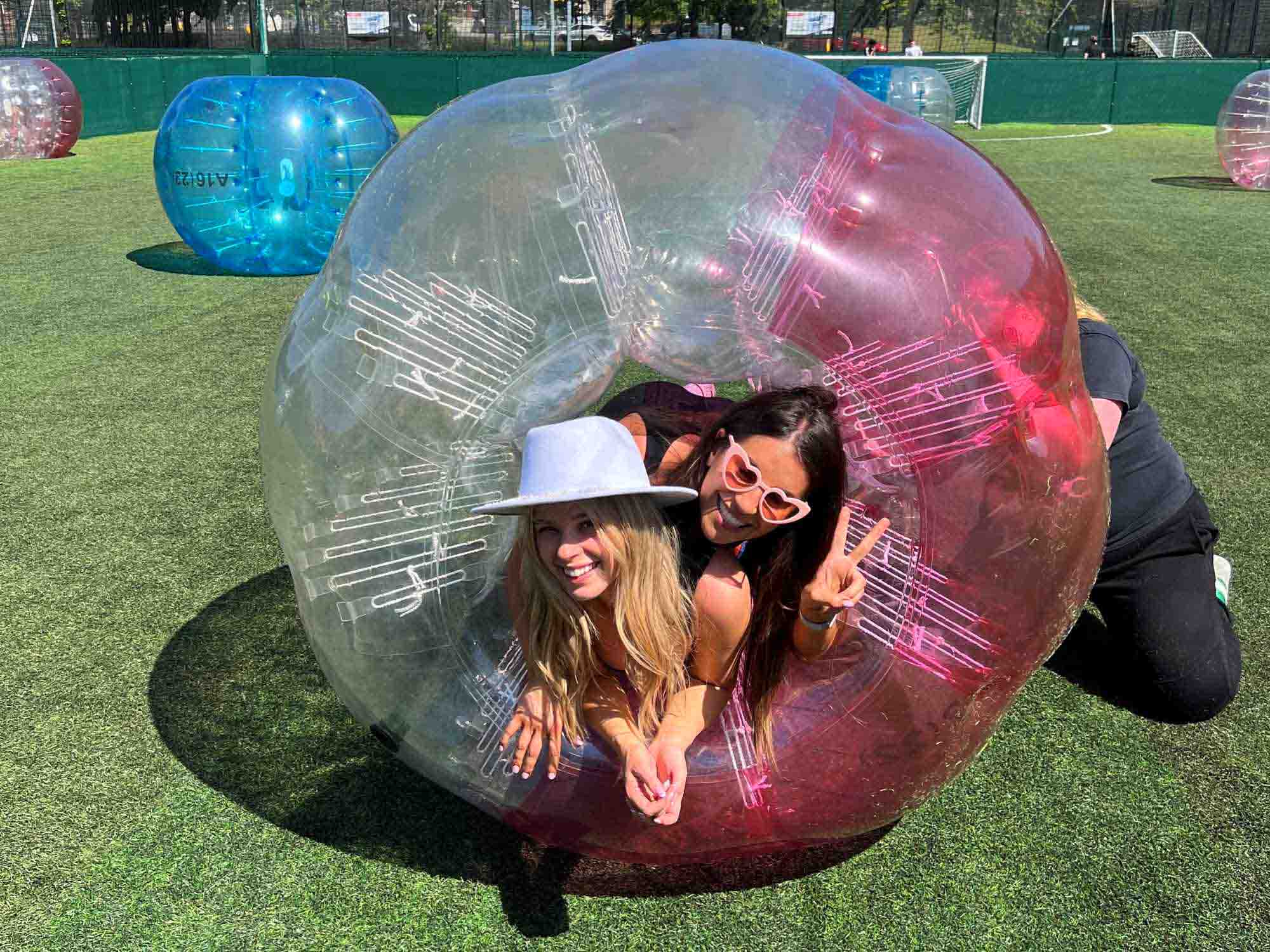Liverpool Bubble Mayhen game – Hen group bouncing around in giant zorbs